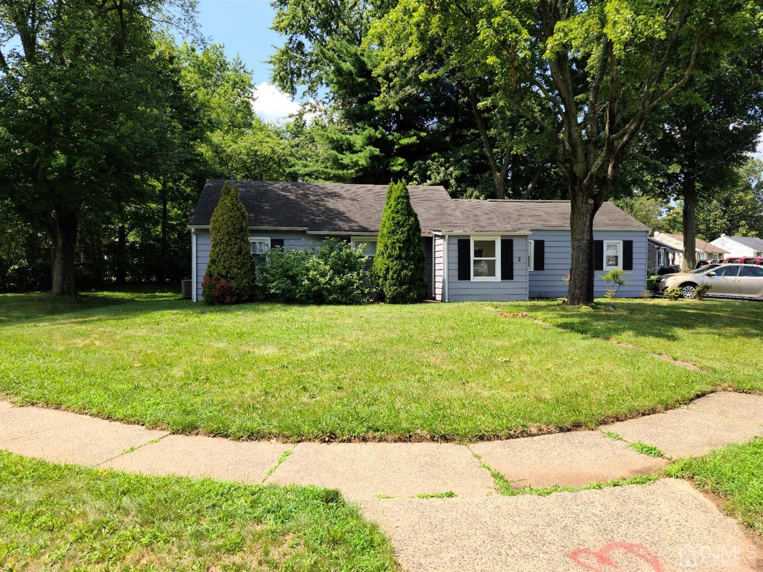 2 East Knollwood Road Edison, NJ 08817 - Photo 1 of 22 a front view of a house with garden