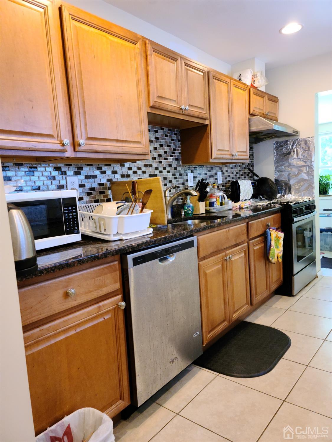 2 East Knollwood Road Edison, NJ 08817 - Photo 6 of 22 a kitchen with stainless steel appliances a stove a sink and a microwave