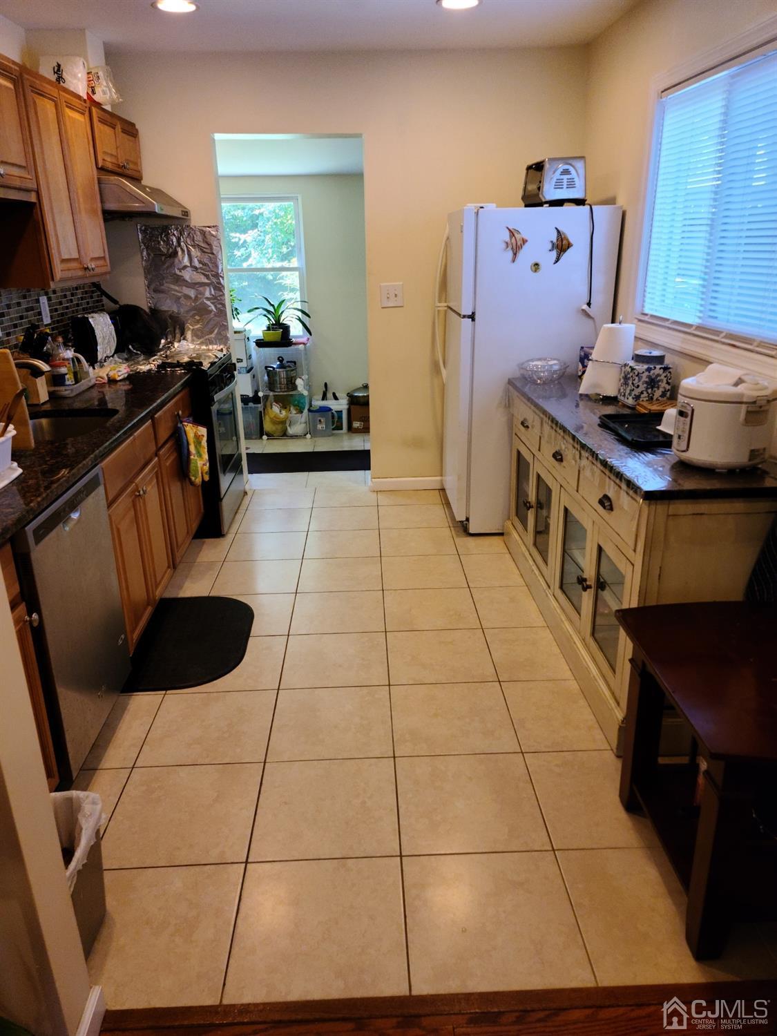 2 East Knollwood Road Edison, NJ 08817 - Photo 7 of 22 a kitchen with a sink and a stove top oven