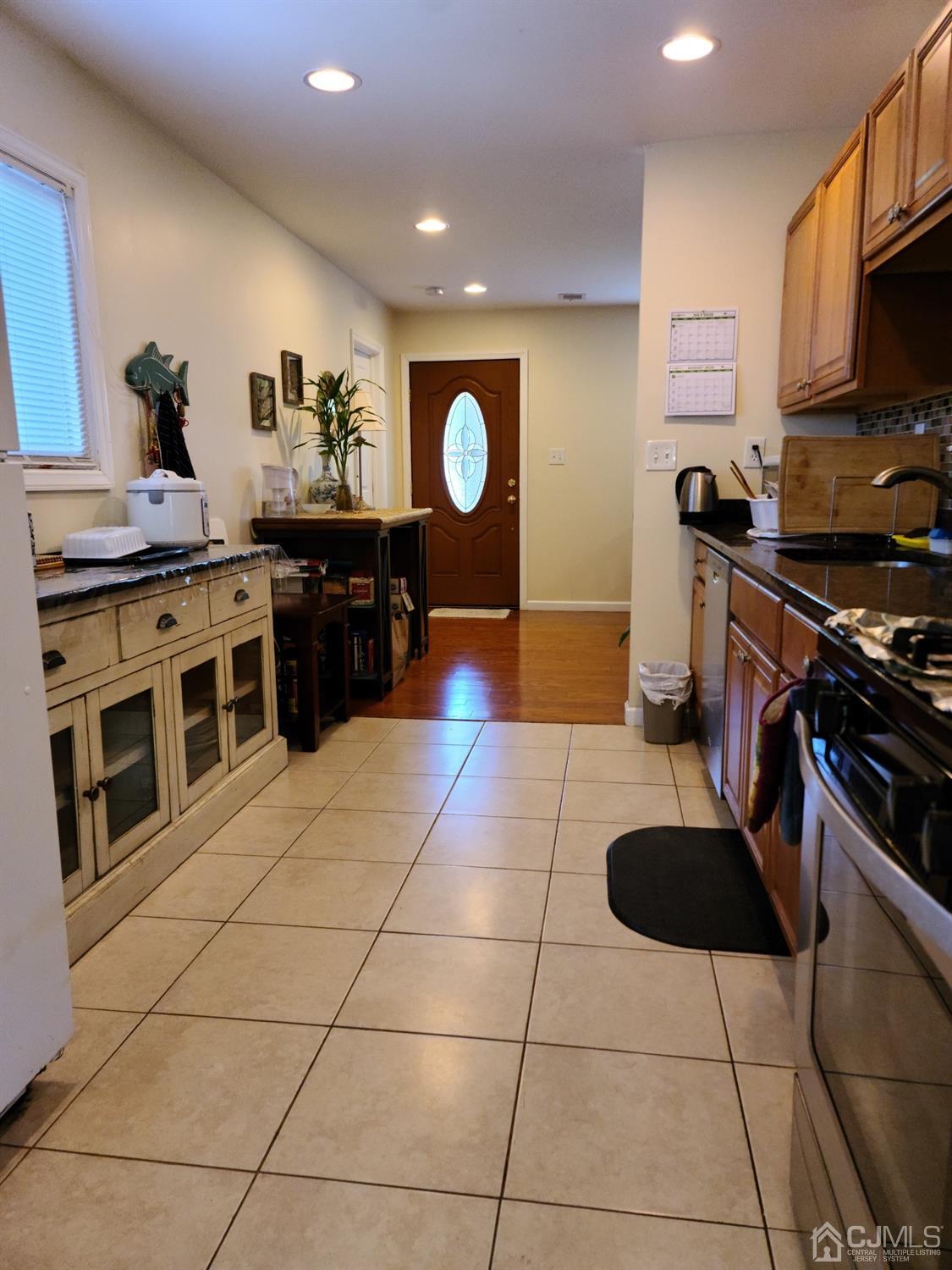 2 East Knollwood Road Edison, NJ 08817 - Photo 8 of 22 a kitchen with stainless steel appliances granite countertop a stove a sink and a microwave