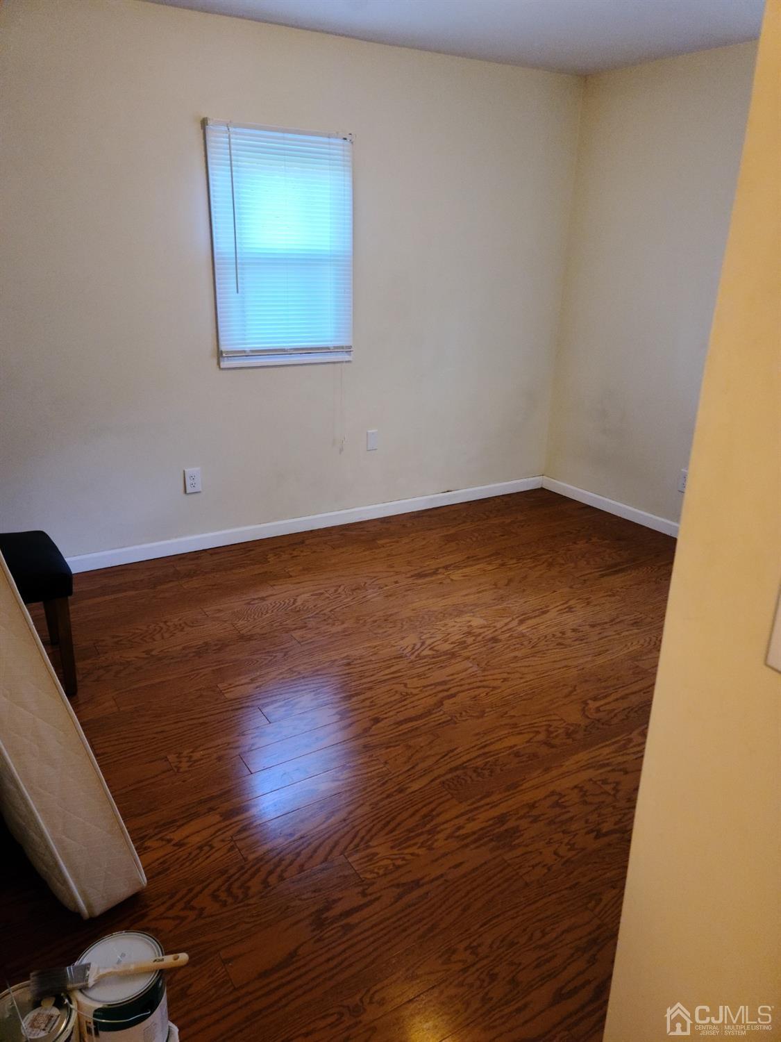 2 East Knollwood Road Edison, NJ 08817 - Photo 10 of 22 a view of an empty room with wooden floor and a window