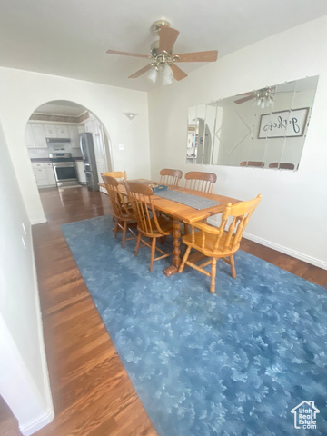 190 600 North Ferron, UT 84523 - Photo 15 of 85 Dining space with arched walkways to the kitchen area, wood floors, and a ceiling fan