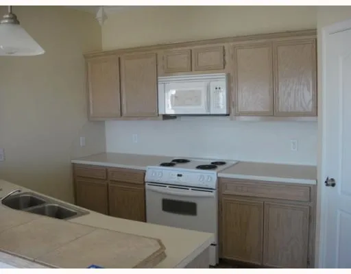 a kitchen with a stove sink and cabinets