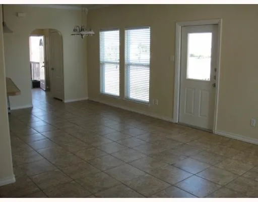 a view of an empty room with glass door