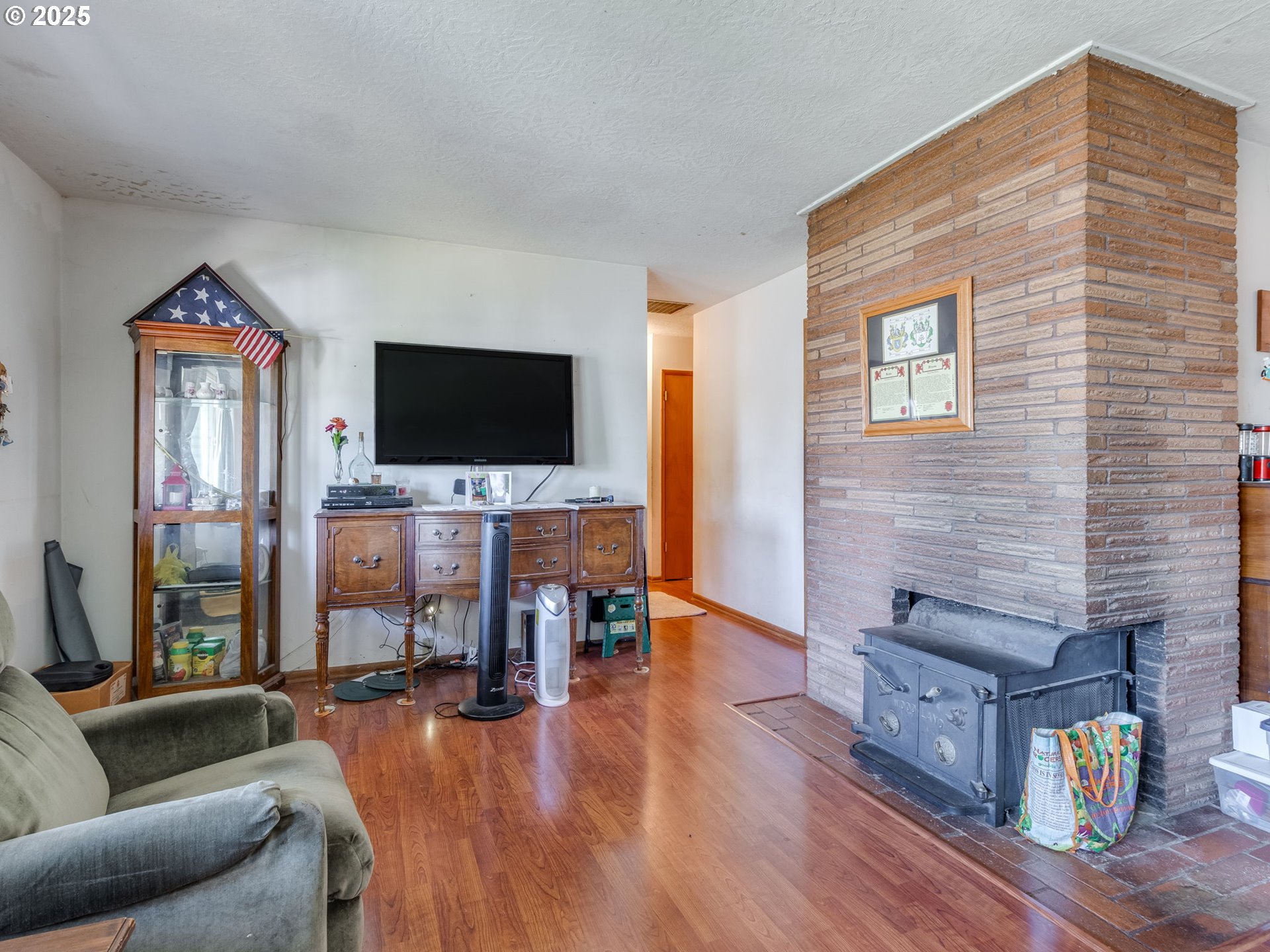 18010 Southeast Stephens Street Portland, OR 97233 - Photo 11 of 30 a living room with furniture and a flat screen tv