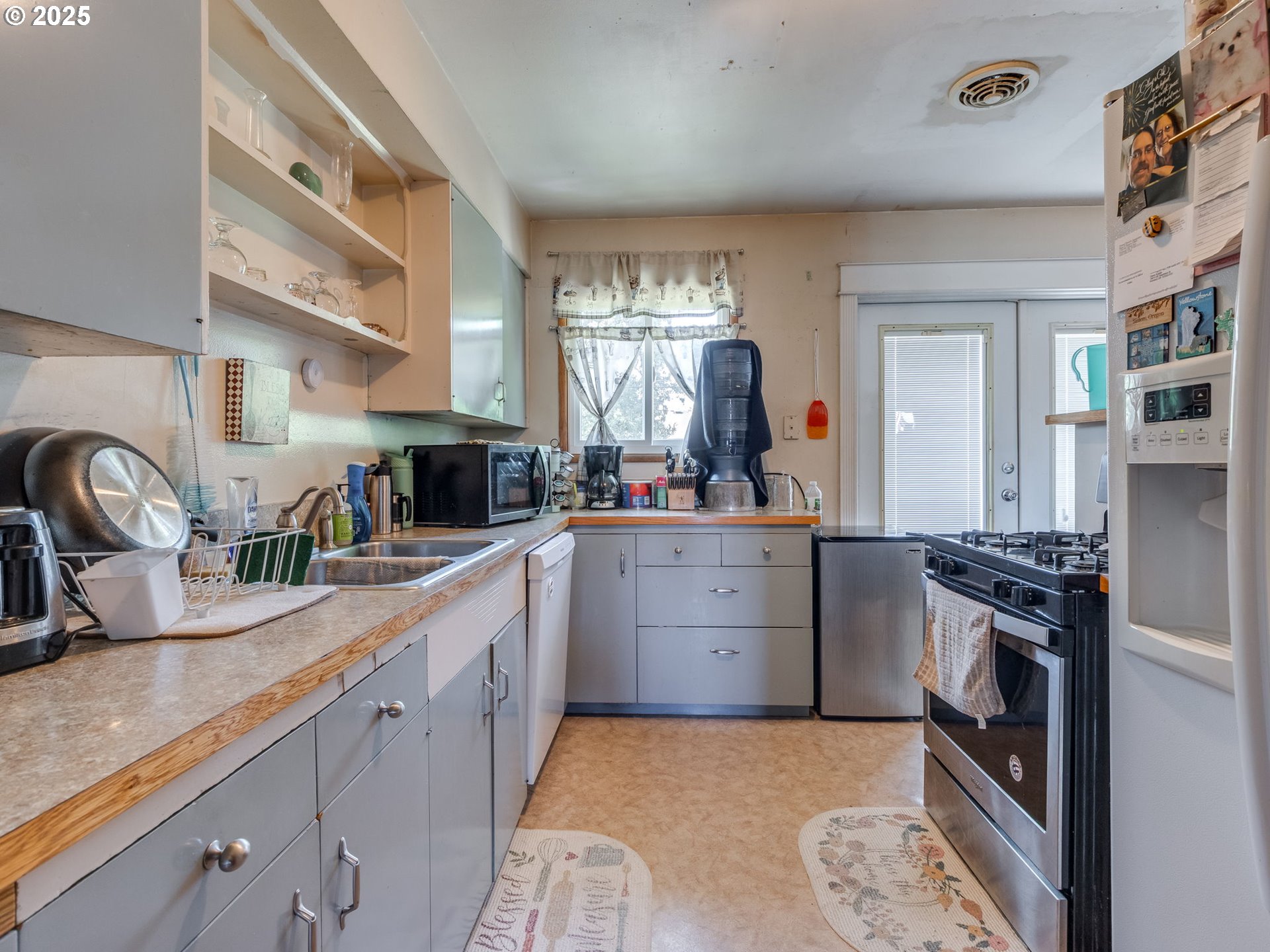 18010 Southeast Stephens Street Portland, OR 97233 - Photo 13 of 30 a kitchen with a stove a sink and a refrigerator