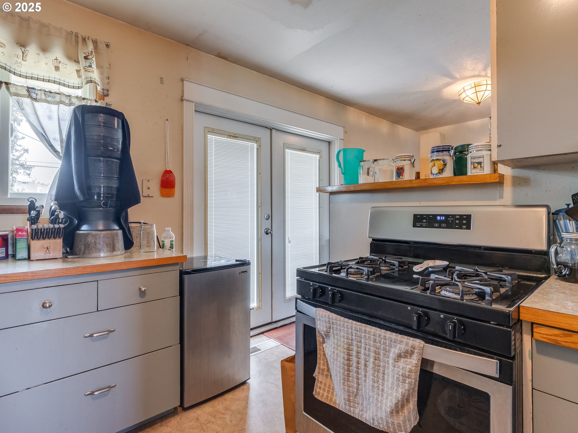 18010 Southeast Stephens Street Portland, OR 97233 - Photo 14 of 30 a kitchen with stainless steel appliances granite countertop a stove and a refrigerator
