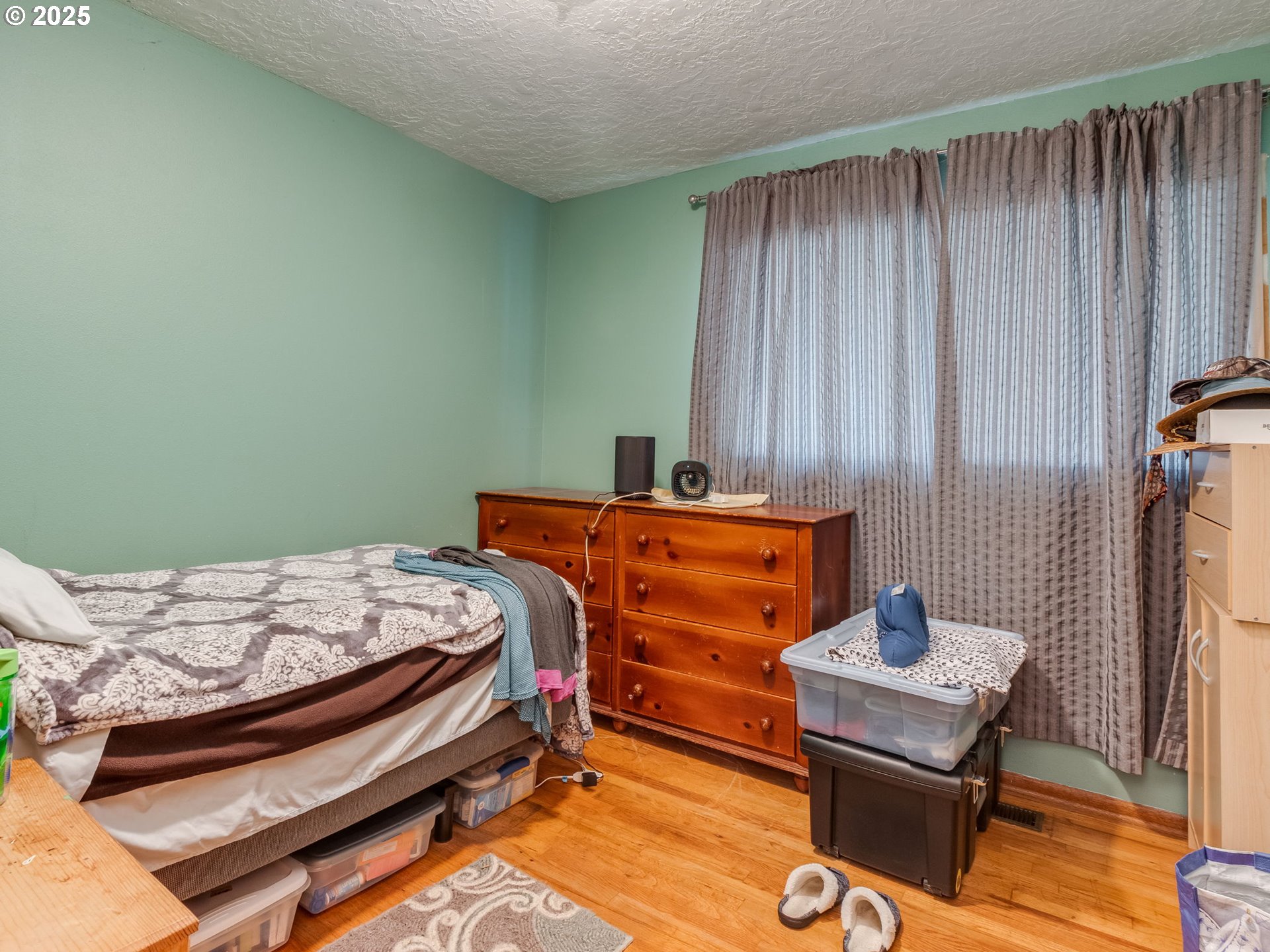 18010 Southeast Stephens Street Portland, OR 97233 - Photo 20 of 30 a bedroom with a bed and a table in it