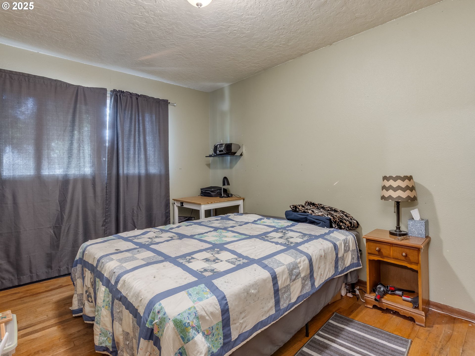18010 Southeast Stephens Street Portland, OR 97233 - Photo 22 of 30 a bedroom with a bed and wooden floor