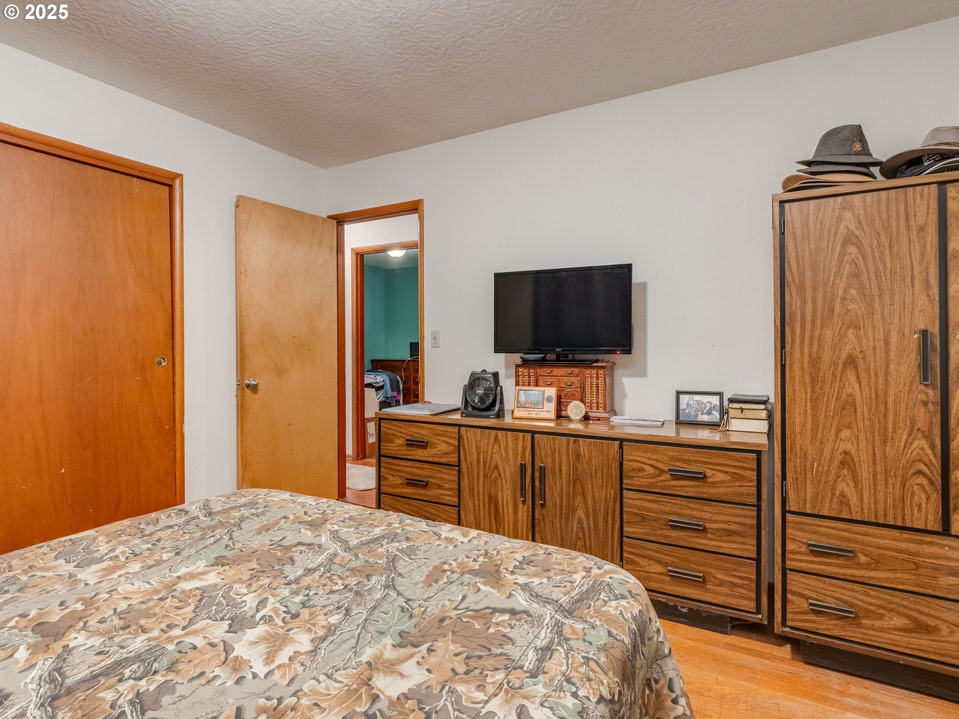 18010 Southeast Stephens Street Portland, OR 97233 - Photo 25 of 30 a bedroom with a bed and wooden floor