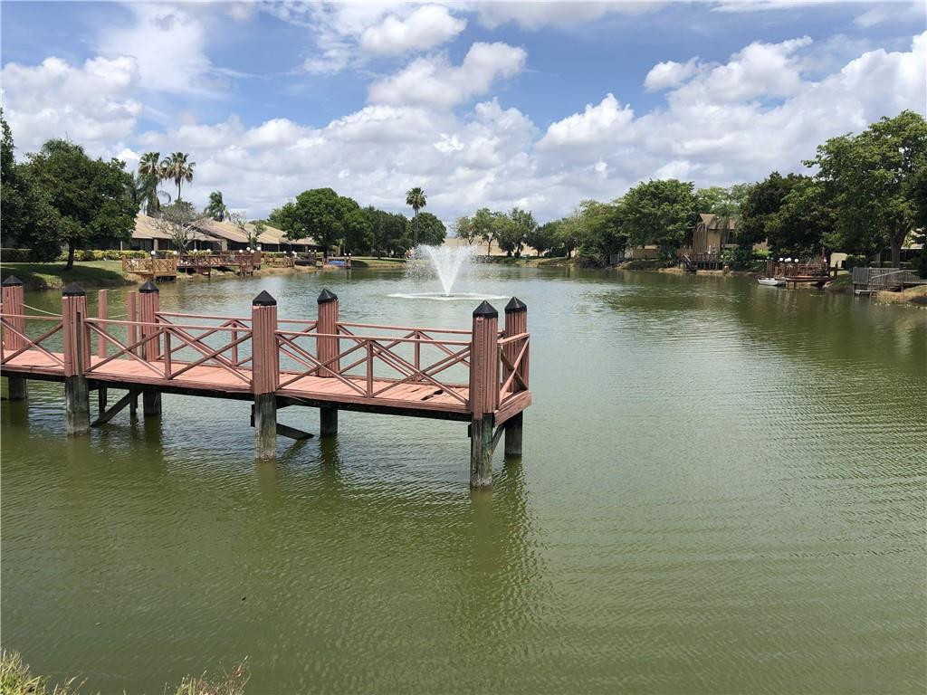 787 Banks Road, Unit 787 Margate, FL 33063 - Photo 27 of 33 a swimming pool with outdoor seating and lake view