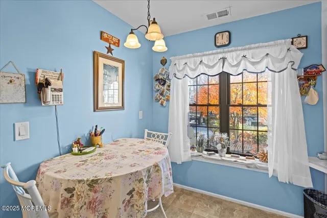 a bedroom with a bed mirror and a window