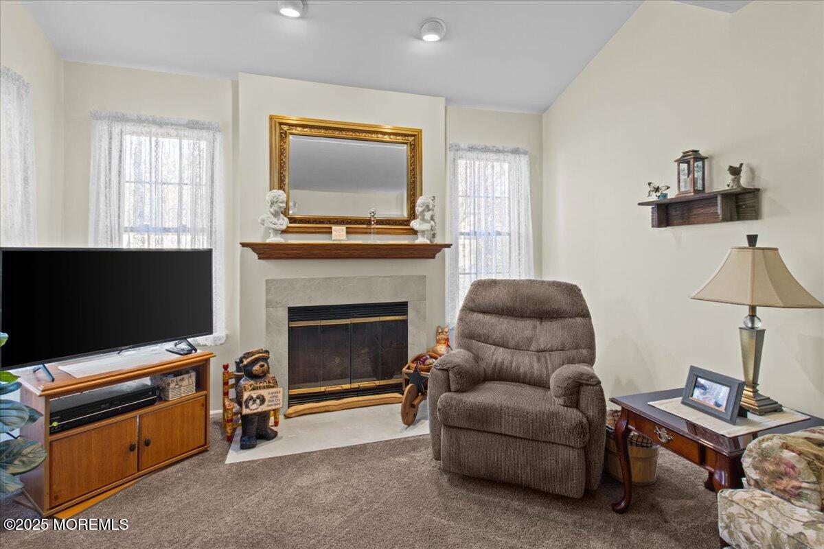94 Paddock Court Oceanport, NJ 07757 - Photo 16 of 38 a living room with furniture a flat screen tv and a fireplace