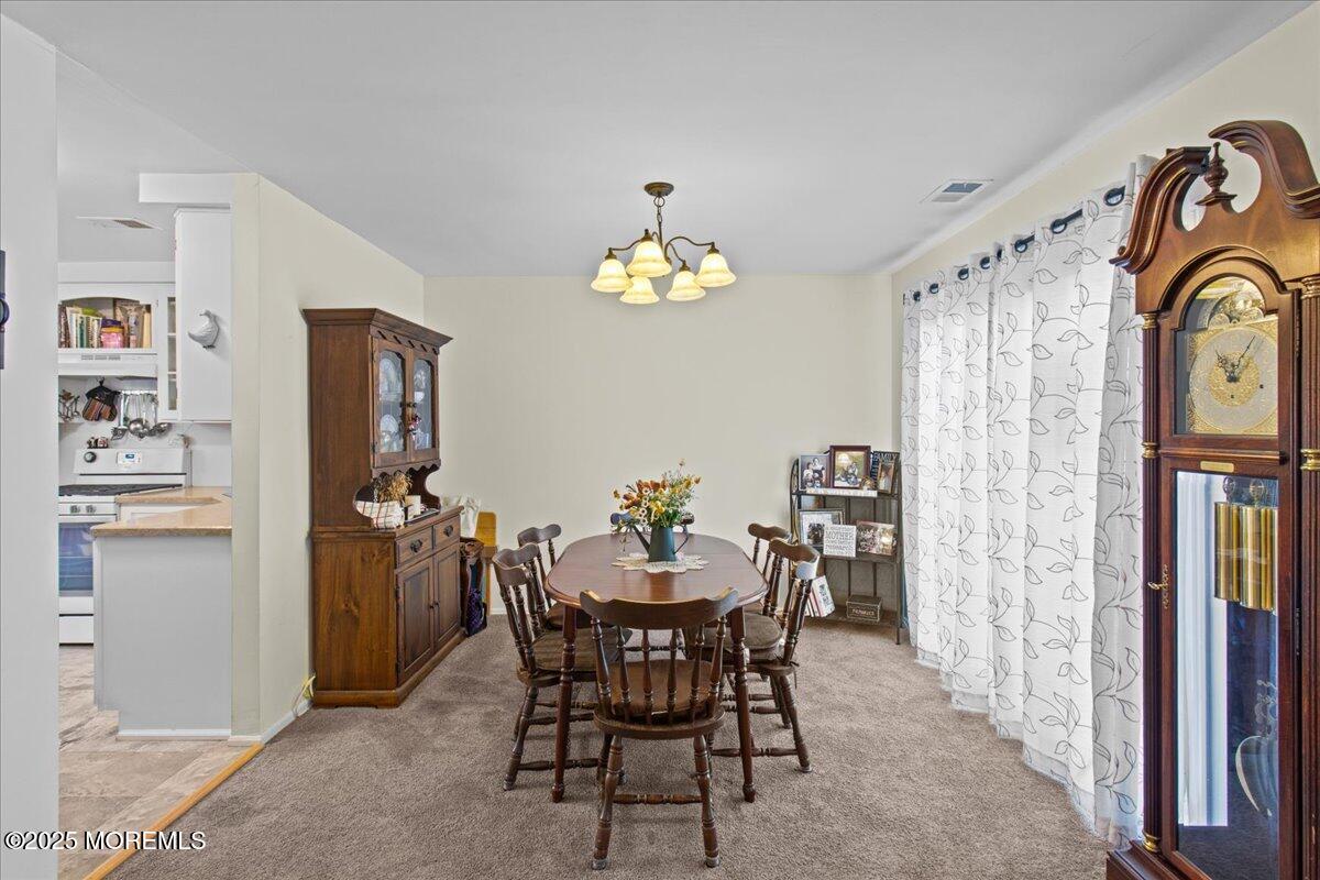 94 Paddock Court Oceanport, NJ 07757 - Photo 18 of 38 a dining room with furniture and chandelier