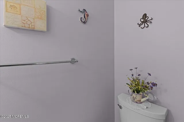 a white vase with flowers