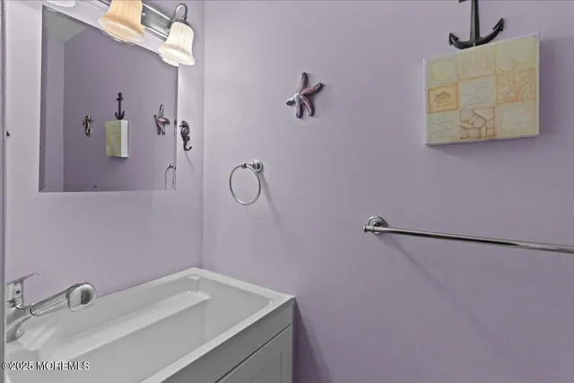 a bathroom with a sink and vanity