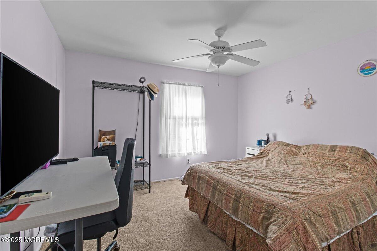 94 Paddock Court Oceanport, NJ 07757 - Photo 26 of 38 a bedroom with a bed tv and a window