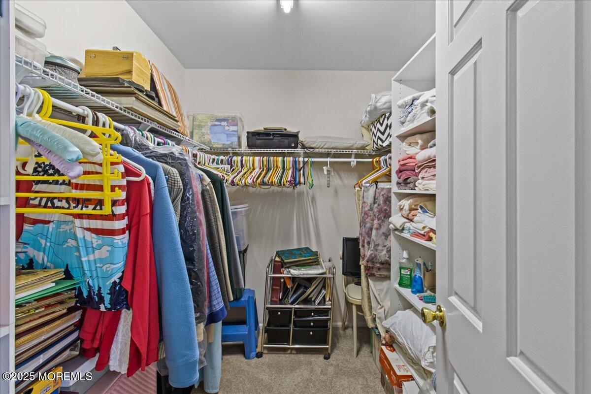 94 Paddock Court Oceanport, NJ 07757 - Photo 9 of 38 a view of walk in closet with clothes and shoes