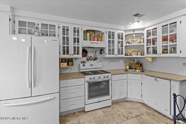 a kitchen with stainless steel appliances granite countertop a stove and a sink