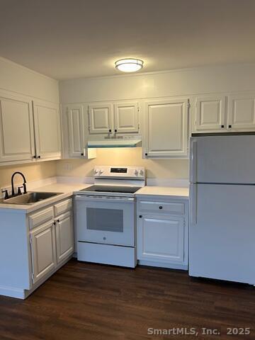 43 A Seaview Avenue, Unit 12 Stamford, CT 06902 - Photo 5 of 10 a kitchen with granite countertop white cabinets and white appliances