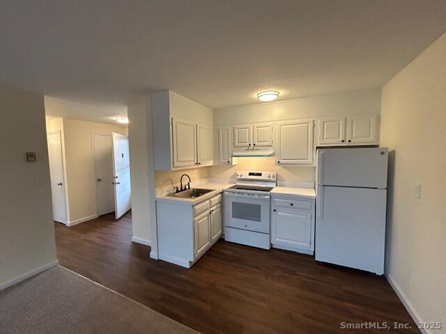 43 A Seaview Avenue, Unit 12 Stamford, CT 06902 - Photo 6 of 10 a kitchen with sink a refrigerator and white cabinets