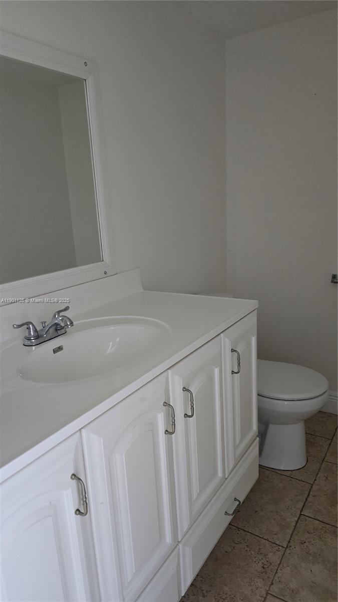 13499 Biscayne Boulevard, Unit 1103 North Miami, FL 33181 - Photo 11 of 20 a bathroom with a sink a toilet and a mirror