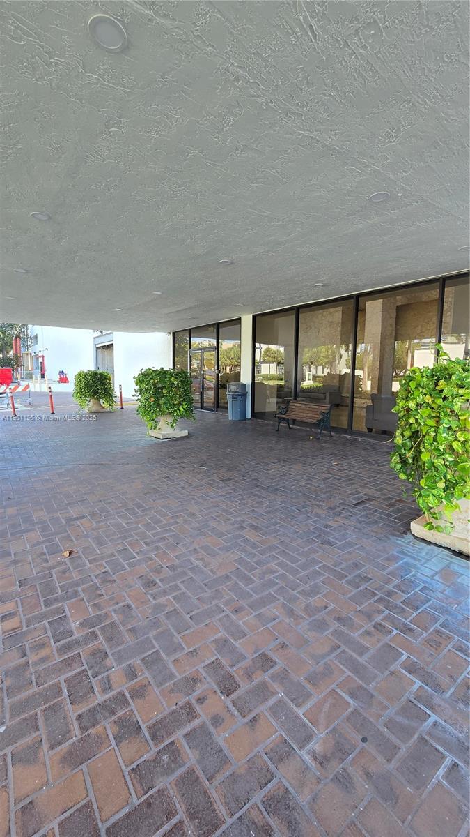 13499 Biscayne Boulevard, Unit 1103 North Miami, FL 33181 - Photo 13 of 20 a view of a house with a yard and garage