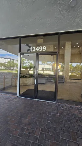 a view of a big room with an empty space and wooden floor