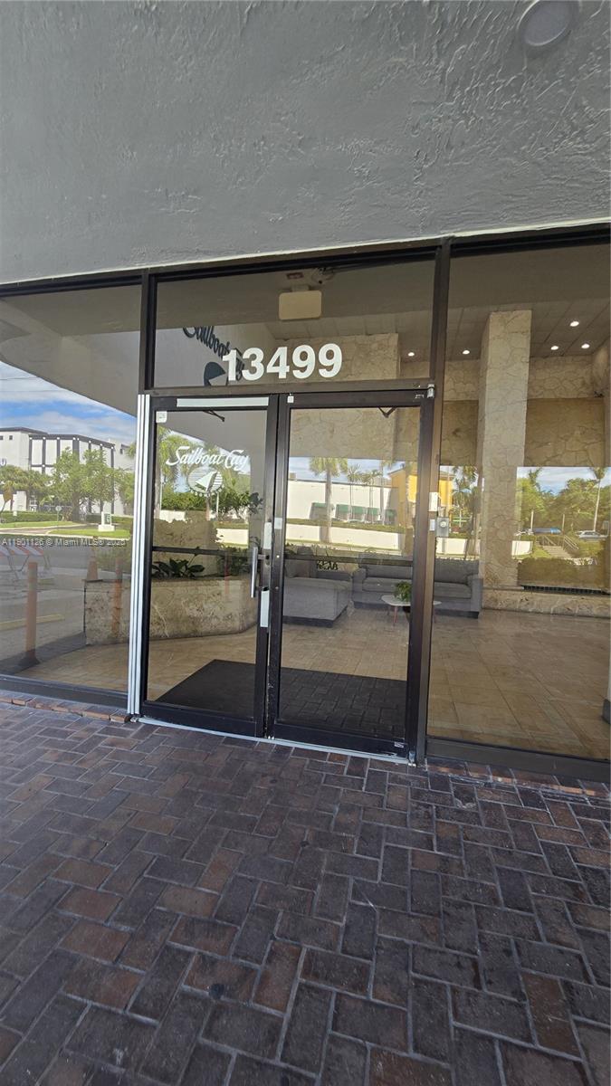 13499 Biscayne Boulevard, Unit 1103 North Miami, FL 33181 - Photo 14 of 20 a view of a big room with an empty space and wooden floor