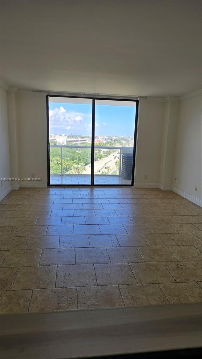 13499 Biscayne Boulevard, Unit 1103 North Miami, FL 33181 - Photo 2 of 20 a view of an empty room with a fireplace