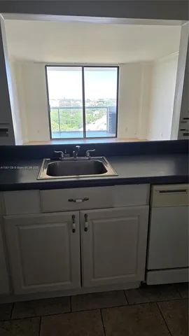 a kitchen with a sink and large window