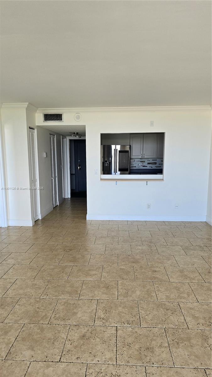 13499 Biscayne Boulevard, Unit 1103 North Miami, FL 33181 - Photo 6 of 20 a view of a livingroom with an empty space and a fireplace