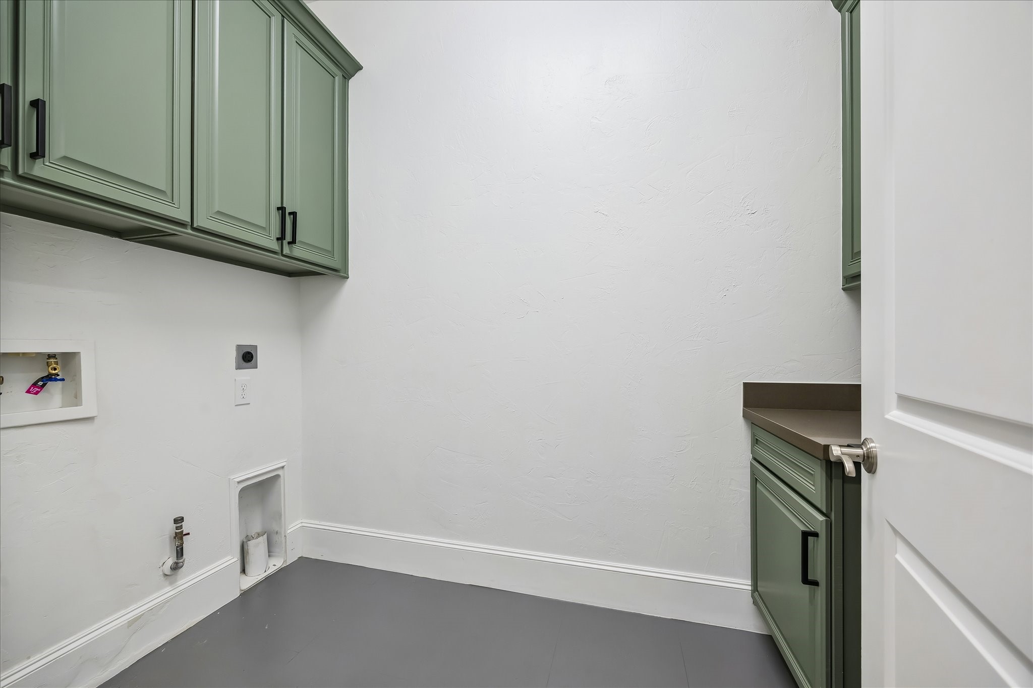 1208 Welch Street Houston, TX 77006 - Photo 23 of 35 The large second floor laundry room is ready for gas or electric, front loading or top loading units. Opposite the washer / dryer space is a folding table, with hanging space behind the door. So nice to have a room for laundry, not just a closet on the hallway!