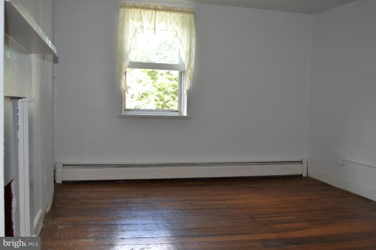 1009 Calvert Road Rising Sun, MD 21911 - Photo 14 of 30 Bedroom with closed off fireplace-Wood floors