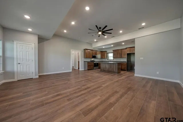 a kitchen with granite countertop wooden cabinets stainless steel appliances and a sink