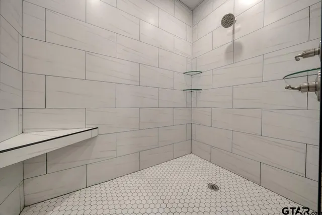 a spacious bathroom with a granite countertop sink a toilet and shower