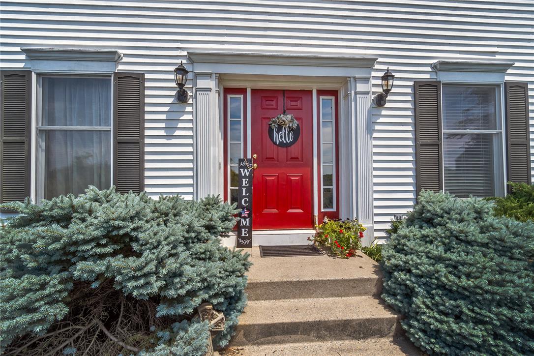 9461 Red Road Kempton, PA 19529 - Photo 2 of 55 A vibrant red entry door creates a striking focal point on this traditional home's façade.
