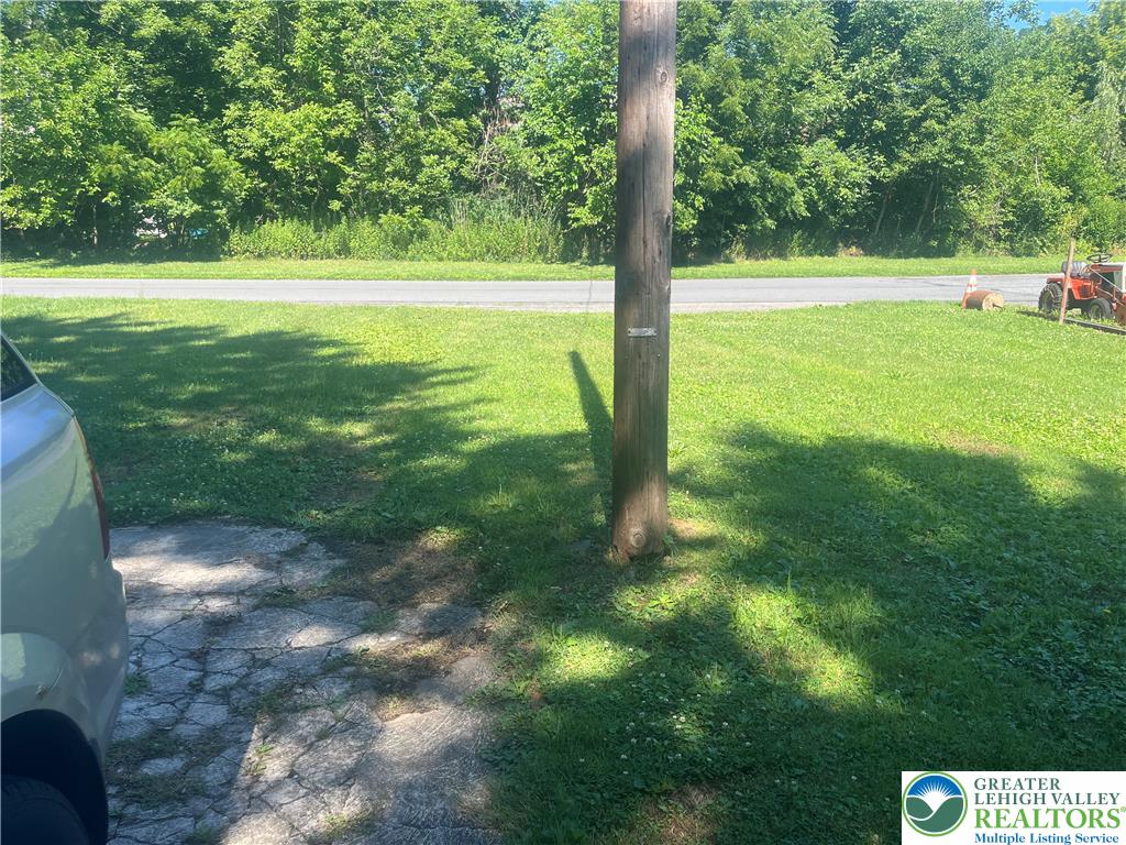1839 Willow Park Road Bethlehem, PA 18020 - Photo 35 of 35 Green landscaping lines the expansive lot, bordered by a quiet, paved road and lush tree cover.