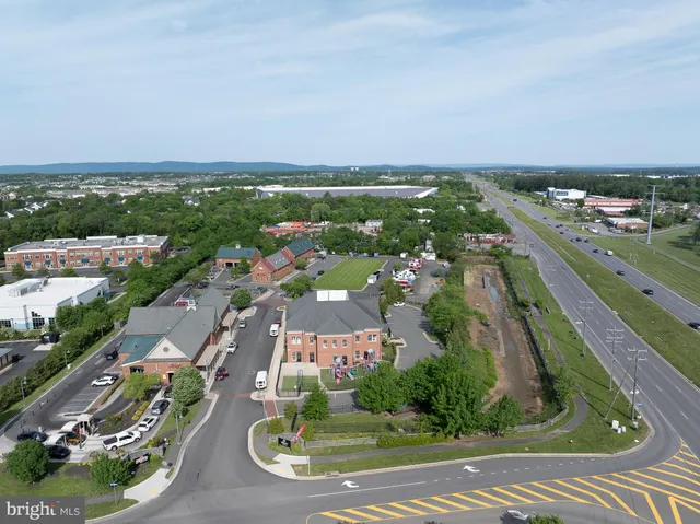 an aerial view of residential houses with outdoor space and trees