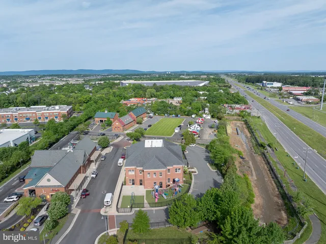an aerial view of residential houses with outdoor space and trees