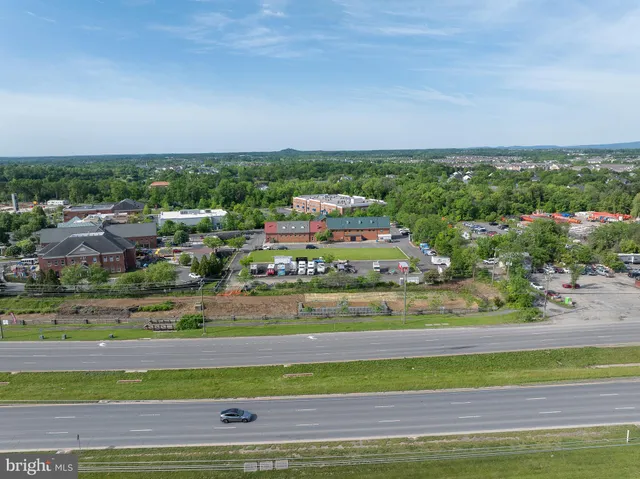 an aerial view of residential houses with outdoor space and river