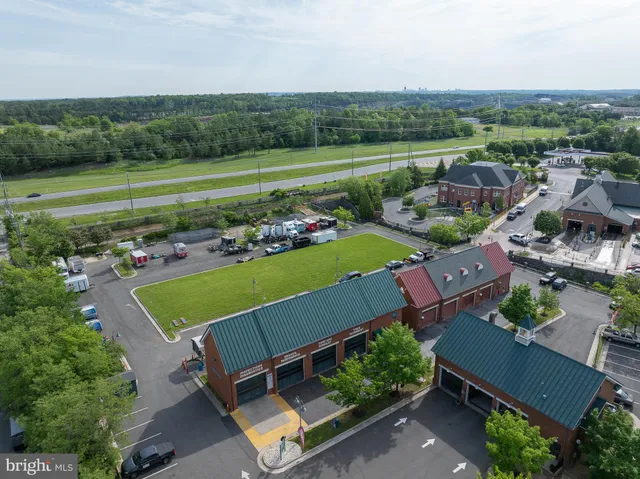 an aerial view of a house with a yard and outdoor seating