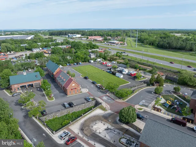 an aerial view of a city with lots of residential buildings ocean and mountain view in back