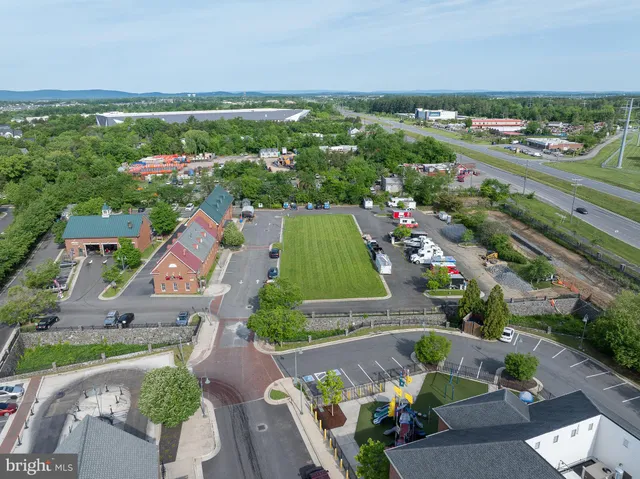 an aerial view of residential houses with outdoor space and street view