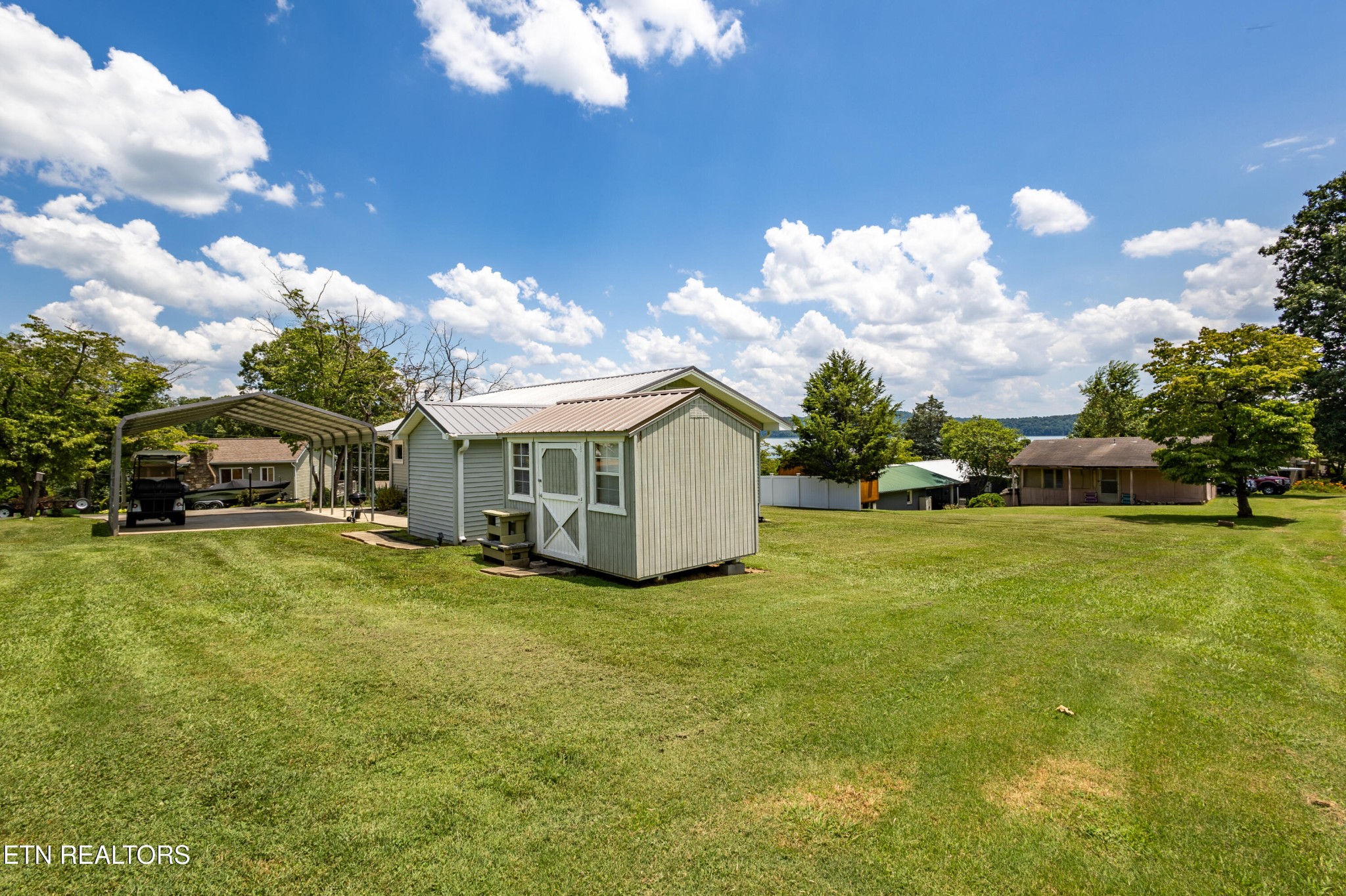 1595 Wa Ni Village Road Rutledge, TN 37861 - Photo 14 of 23 a yellow house with a big yard and large trees