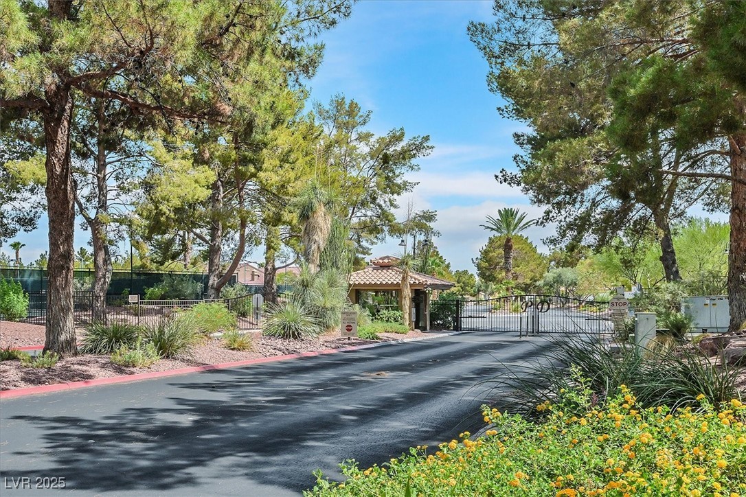 5421 Painted Mirage Road Las Vegas, NV 89149 - Photo 33 of 35 View of street featuring a gate, curbs, and a gated entry