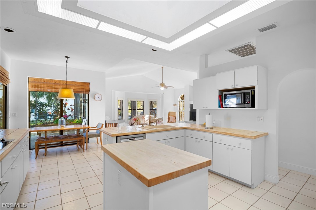 11772 Mahogany Run Fort Myers, FL 33913 - Photo 15 of 50 a large white kitchen with a sink and cabinets