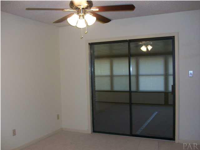 6640 Bellview Pines Road Pensacola, FL 32526 - Photo 14 of 22 Master bedroom viewing the Sunroom. New carpet and ceiling fan. Just painted!!!