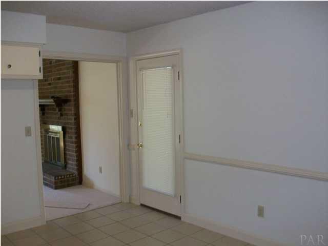 6640 Bellview Pines Road Pensacola, FL 32526 - Photo 20 of 22 KITCHEN LOOKING INTO LIVINGROOM AND SIDE DOOR TO OUTSIDE