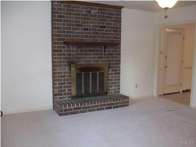 6640 Bellview Pines Road Pensacola, FL 32526 - Photo 7 of 22 Livingroom has fireplace for those cozy times, or intertaining.